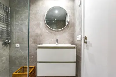 a bathroom with a sink and a mirror at AIGUADOLÇ APARTMENT in Sitges
