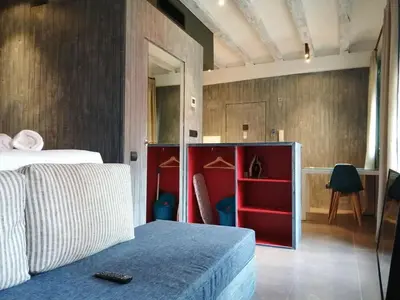 a bedroom with a bed and a red cabinet at Beachfront apartment Barceloneta Street in Barcelona