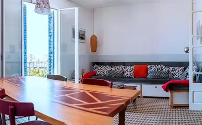a living room with a wooden table and a couch at Entire Flat First Beach line - Sea Views - Vilanova i Geltru in Vilanova i la Geltrú
