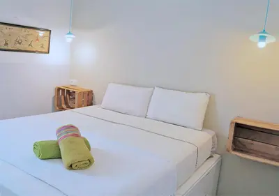 a bedroom with a bed with a towel on it at Entire Flat First Beach line - Sea Views - Vilanova i Geltru in Vilanova i la Geltrú