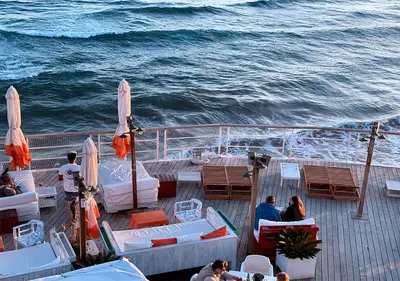a group of people sitting on the deck of a boat at Entire Flat First Beach line - Sea Views - Vilanova i Geltru in Vilanova i la Geltrú
