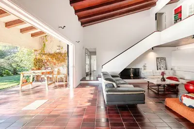 a living room with a couch and a table at Villa Exclusiva 12 Personas con Piscina, Barbacoa y Vistas al Mar en Maresme Barcelona in Sant Vicenç de Montalt