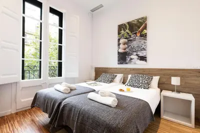 a bedroom with two beds with towels on them at 2905 - AB Comte dUrgell I-II in Barcelona