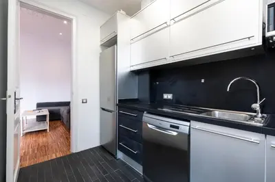 a kitchen with white cabinets and a sink at 2905 - AB Comte dUrgell I-II in Barcelona