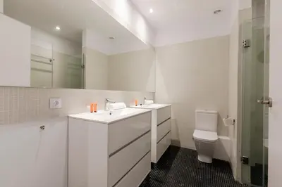 a white bathroom with a sink and a toilet at 2905 - AB Comte dUrgell I-II in Barcelona