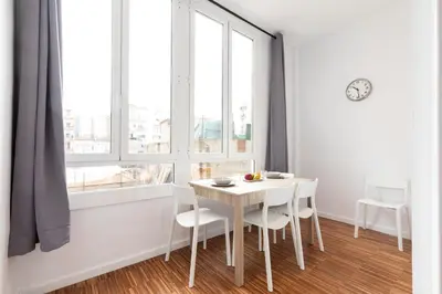 a white dining room with a white table and chairs at 2905 - AB Comte dUrgell I-II in Barcelona