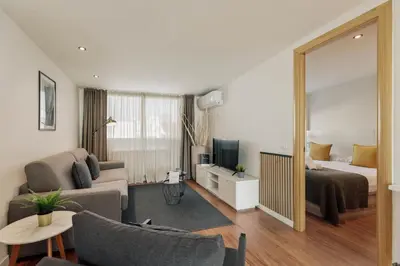 a living room with a couch and a bed and a mirror at Sitges Group Beach Dreams in Sitges