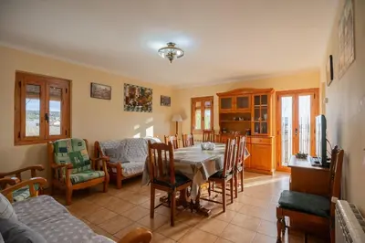 a living room with a dining table and chairs at Mas Prat in Pla del Panadés