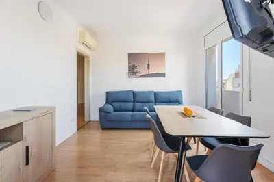 a living room with a blue couch and a table at 4151 - AB Sagrada Familia Views VII-II in Barcelona