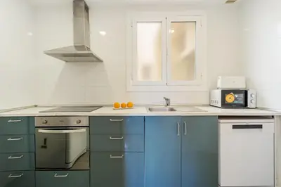 a kitchen with blue cabinets and a sink at 4151 - AB Sagrada Familia Views VII-II in Barcelona