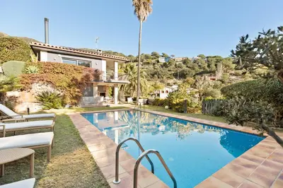 a swimming pool in front of a house at Chez Pablo Barcelona in Cabrils