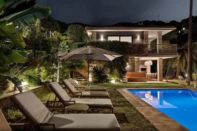 a villa with a swimming pool at night at Chez Pablo Barcelona in Cabrils