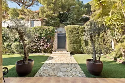 two potted trees in pots in a garden at Chez Pablo Barcelona in Cabrils