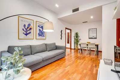 a living room with a couch and a table at Acogedor apartamento en el corazón de Sant Antoni in Barcelona