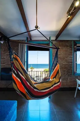 a hammock in a living room with a view of the ocean at Beach apartment with sea views in Barcelona