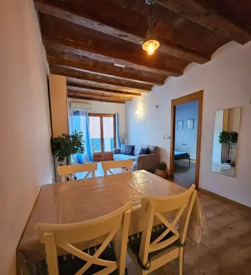 a dining room with a wooden table and chairs at Flat with 2 rooms and private terrace min 32 days in Barcelona