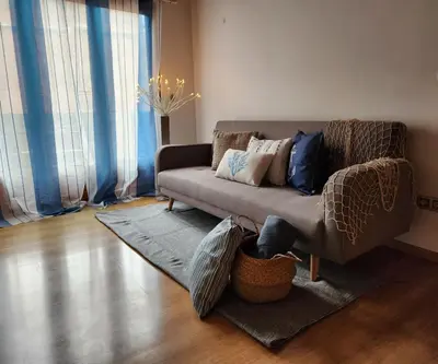a living room with a couch with pillows on it at Flat with 2 rooms and private terrace min 32 days in Barcelona