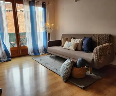 a living room with a couch with pillows on it at Flat with 2 rooms and private terrace min 32 days in Barcelona