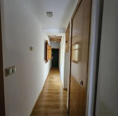 an empty hallway with white walls and wooden floors at Flat with 2 rooms and private terrace min 32 days in Barcelona