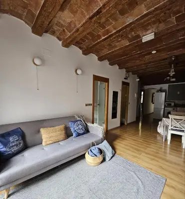 a living room with a couch and a table at Flat with 2 rooms and private terrace min 32 days in Barcelona