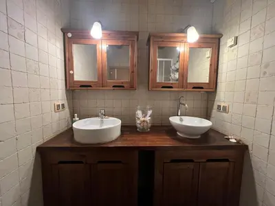 a bathroom with two sinks and two mirrors at Flat with 2 rooms and private terrace min 32 days in Barcelona