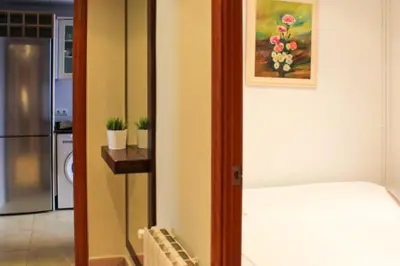 a room with a bed and a painting on the wall at Apartamento Sitges Can Robert in Sitges
