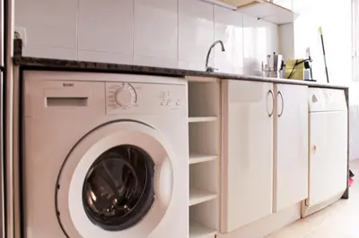 a washing machine in a kitchen with a sink at Apartamento Sitges Can Robert in Sitges