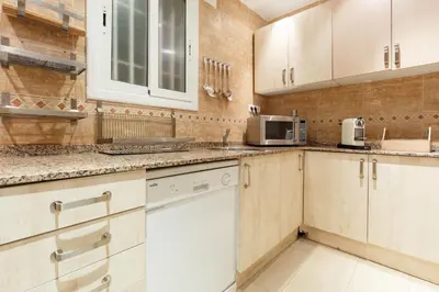 a kitchen with white cabinets and a microwave at Marina in Barcelona