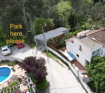 an aerial view of a house and a pool at Forest Escape near Barcelona in Sant Cugat del Vallès