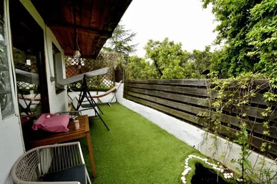 a backyard with green grass and a fence at Forest Escape near Barcelona in Sant Cugat del Vallès