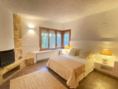 a bedroom with a bed and a flat screen tv at Villa Juny Best view in North Barcelona Coast in Cabrils