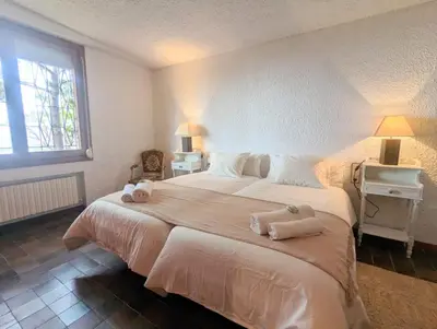 a bedroom with a large bed with towels on it at Villa Juny Best view in North Barcelona Coast in Cabrils