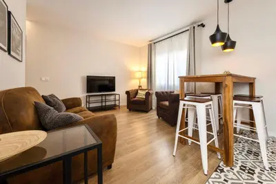 a living room with a couch and a table at MadreMia - Wow Hub Barcelona in Hospitalet de Llobregat