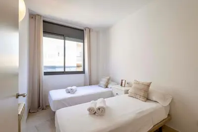 two beds in a room with a window at Apartment for 6, spacious and bright in Bonanova in Barcelona