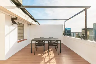 a balcony with a table and chairs on it at Penthouse with Terrace near Gran Via and Camp Nou in Barcelona