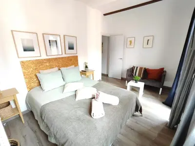 a bedroom with a bed with two towels on it at Bright and cozy 2 rooms apartment in Hospitalet de Llobregat