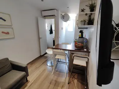 a small kitchen with a table and chairs in a room at Bright and cozy 2 rooms apartment in Hospitalet de Llobregat