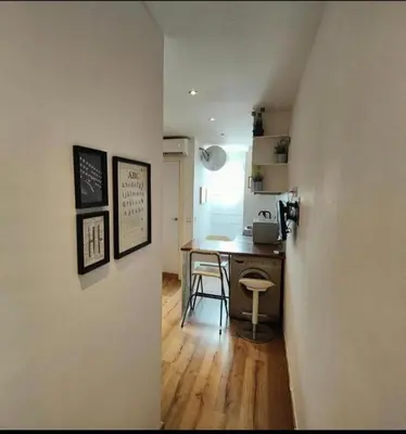 a kitchen with a table and a desk in a room at Bright and cozy 2 rooms apartment in Hospitalet de Llobregat