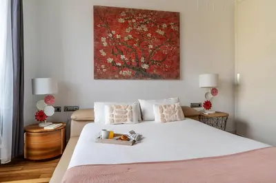 a bedroom with a bed with a painting on the wall at 4101 - AB Passeig de Gràcia Plaça Catalunya I in Barcelona
