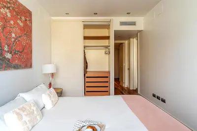 a bedroom with a white bed and a closet at 4101 - AB Passeig de Gràcia Plaça Catalunya I in Barcelona