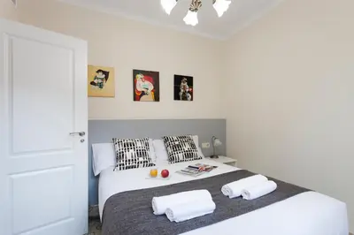 a bedroom with a white bed with two pillows at 2582 - AB Sagrada Familia Marina in Barcelona