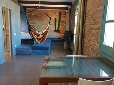 a glass table with a hammock in a room at Barceloneta Mar Beach - BM32 in Barcelona