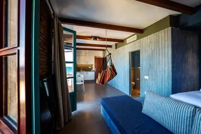 a living room with a blue couch and a kitchen at Barceloneta Mar Beach - BM32 in Barcelona