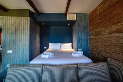 a bedroom with a bed with two pillows and a couch at Barceloneta Mar Beach - BM32 in Barcelona