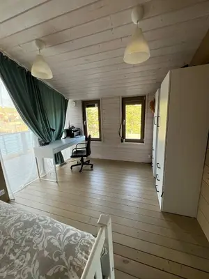 a bedroom with a bed and a desk in a room at La Dacha Montanya in Seva