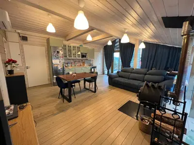 a living room with a couch and a table at La Dacha Montanya in Seva