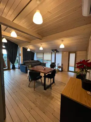 a living room with a table and a couch at La Dacha Montanya in Seva