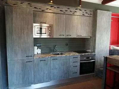 a kitchen with a sink and a microwave at Barceloneta Mar Vela -BM14 in Barcelona