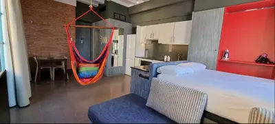 a room with a bed and a hammock in a kitchen at Barceloneta Mar Vela -BM14 in Barcelona