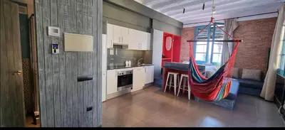 a kitchen with a hammock hanging in a room at Barceloneta Mar Vela -BM14 in Barcelona